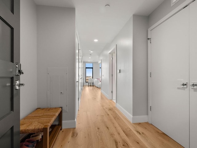 hallway with recessed lighting, baseboards, and light wood finished floors