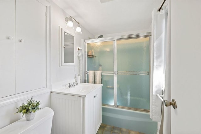 full bathroom featuring enclosed tub / shower combo, vanity, and toilet