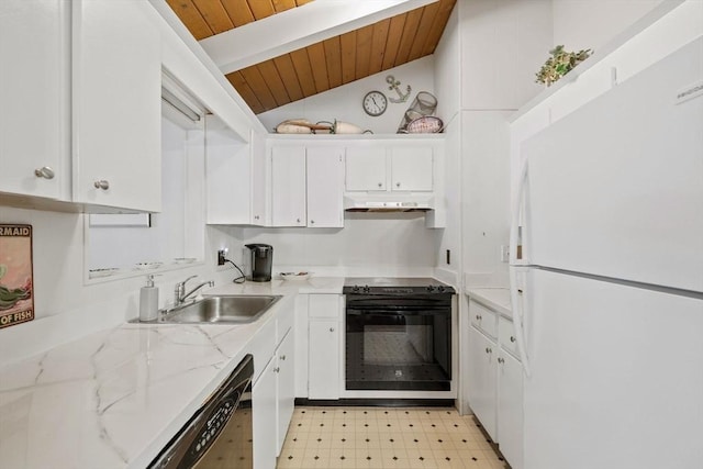 kitchen with light floors, freestanding refrigerator, white cabinets, a sink, and oven