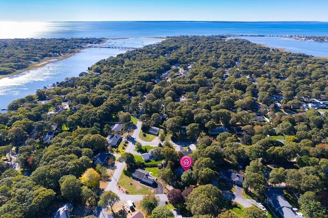 aerial view with a forest view and a water view