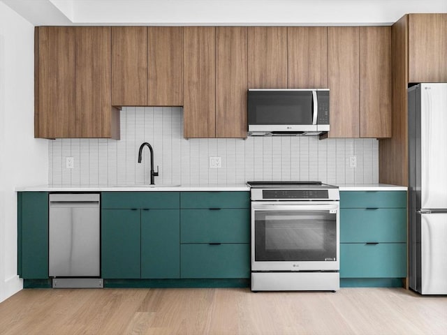 27 Dixwell Unit 1, Boston, MA 02119 - kitchen featuring appliances with stainless steel finishes, a sink, light countertops, and tasteful backsplash