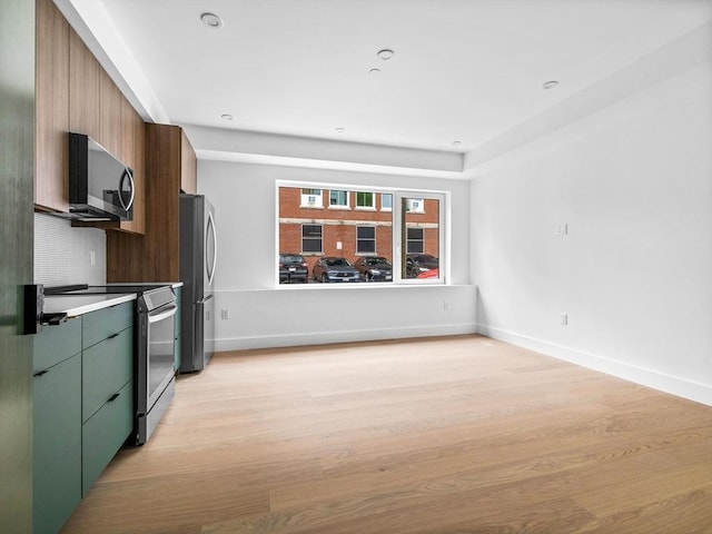 27 Dixwell Unit 1, Boston, MA 02119 - kitchen with stainless steel appliances, light wood-type flooring, baseboards, and green cabinets