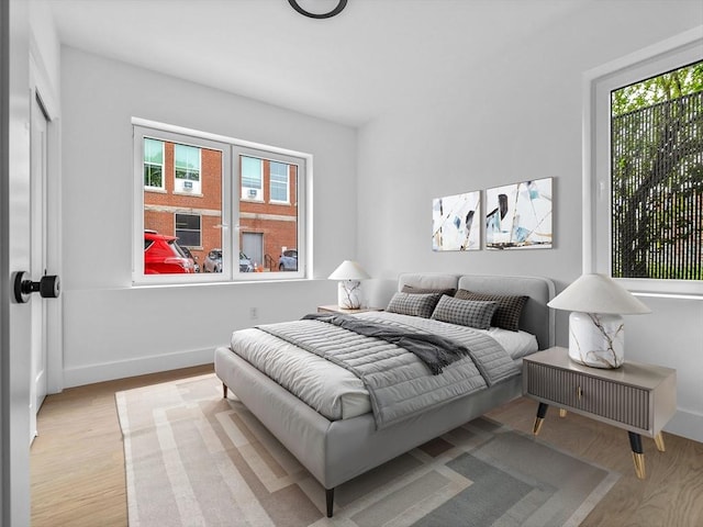 27 Dixwell Unit 1, Boston, MA 02119 - bedroom with multiple windows, wood finished floors, and baseboards