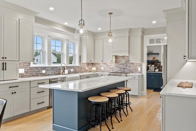170 Lafayette Ave, Wrentham, MA 02093 - kitchen featuring tasteful backsplash, a kitchen bar, light wood finished floors, a center island, and recessed lighting