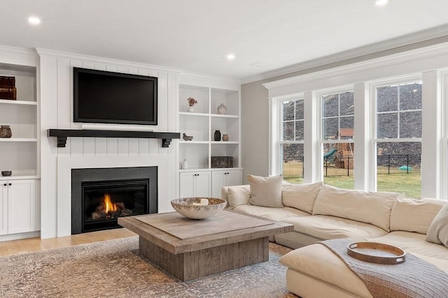 170 Lafayette Ave, Wrentham, MA 02093 - living room with ornamental molding, wood finished floors, built in features, a large fireplace, and recessed lighting