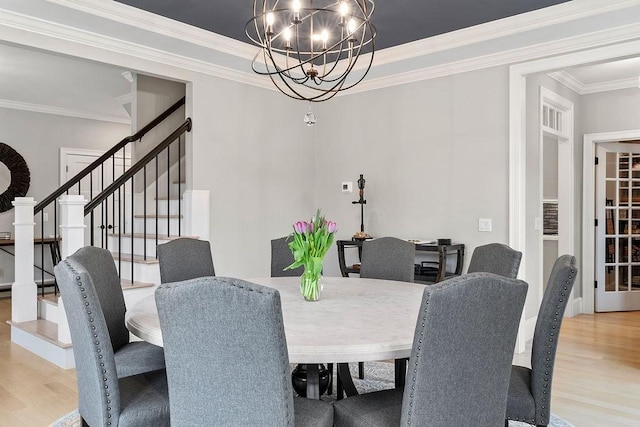 170 Lafayette Ave, Wrentham, MA 02093 - dining area featuring wood finished floors, stairway, ornamental molding, and a chandelier
