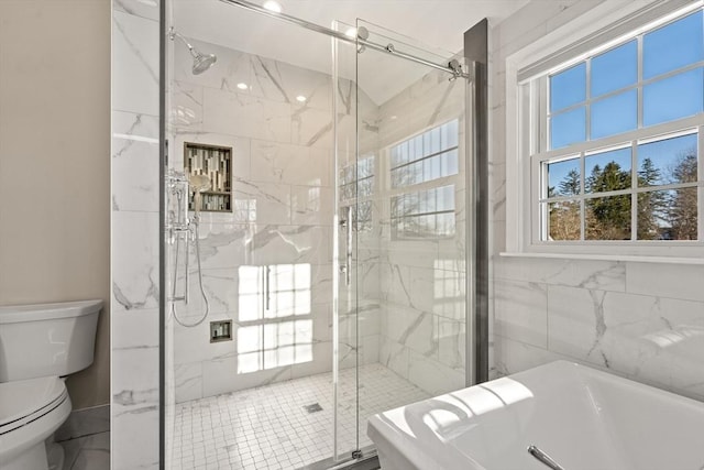 bathroom featuring separate shower and tub and toilet