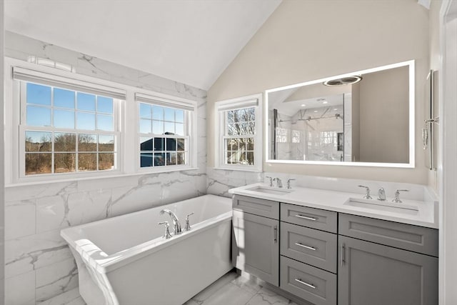 bathroom with vanity, lofted ceiling, and shower with separate bathtub