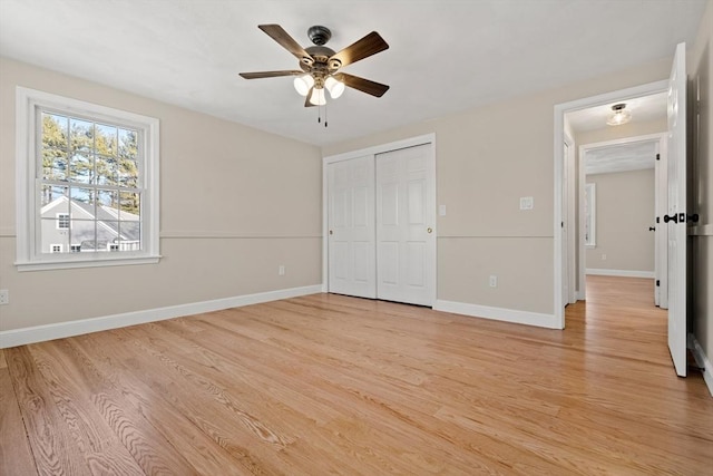 unfurnished bedroom featuring ceiling fan, light hardwood / wood-style floors, and a closet