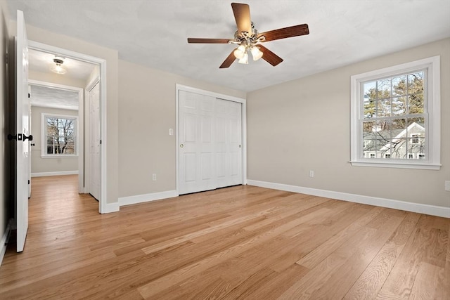 unfurnished bedroom with a closet, ceiling fan, and light hardwood / wood-style flooring