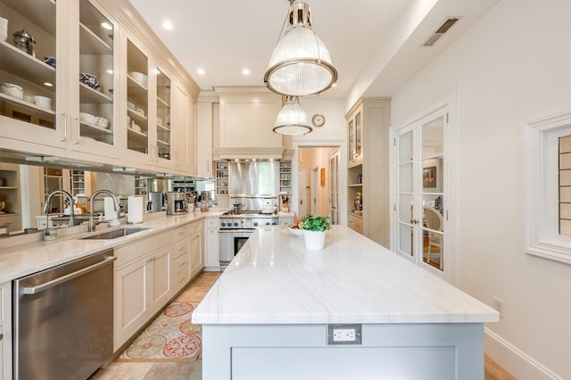 kitchen with a center island, sink, hanging light fixtures, and stainless steel appliances