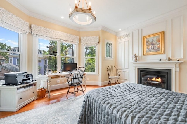 bedroom featuring light wood-type flooring and crown molding