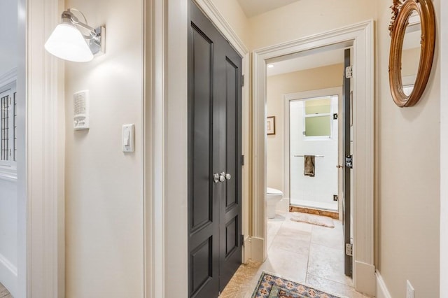 corridor featuring light tile patterned flooring