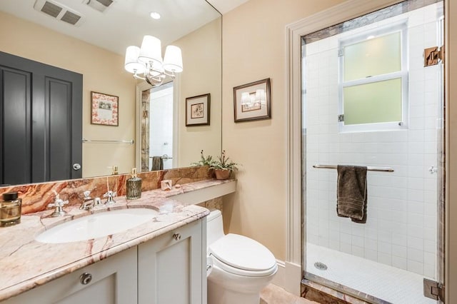 bathroom featuring vanity, toilet, walk in shower, and an inviting chandelier