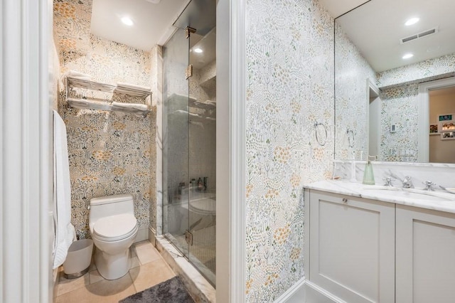 bathroom featuring vanity, toilet, and a shower with door