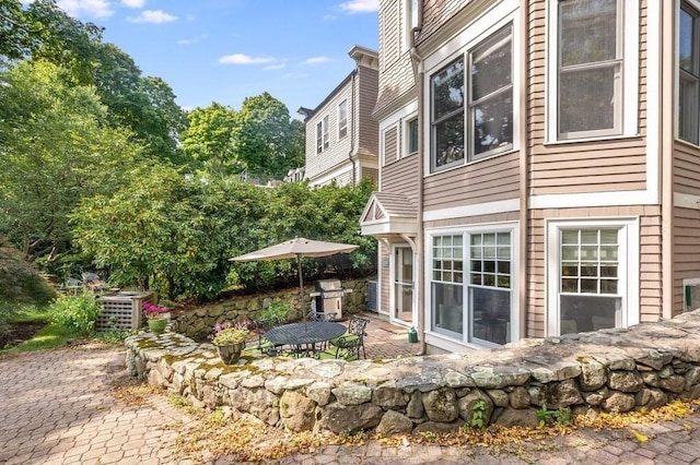 view of side of home with a patio area