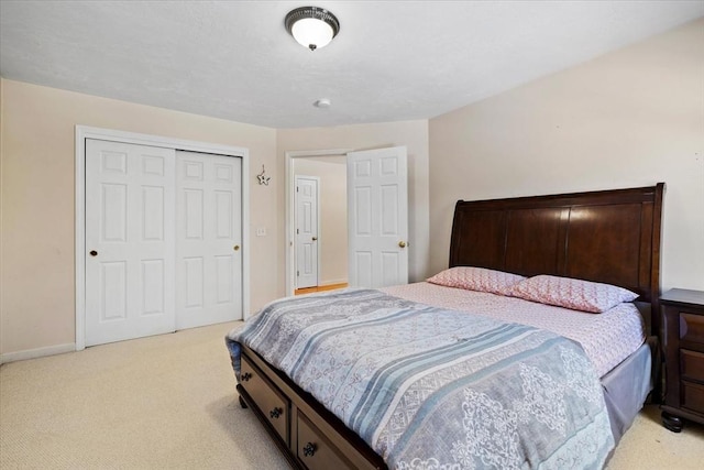 bedroom with light colored carpet and a closet