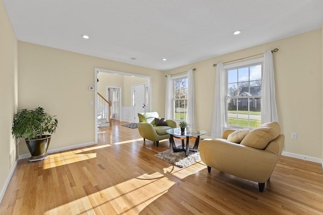 sitting room with stairway, baseboards, recessed lighting, and wood finished floors