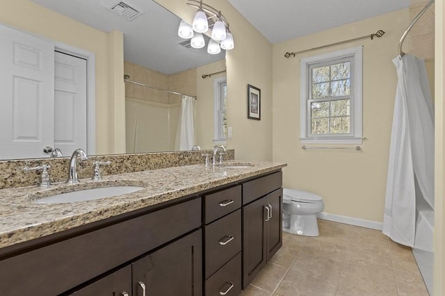 bathroom featuring a sink, baseboards, toilet, and visible vents