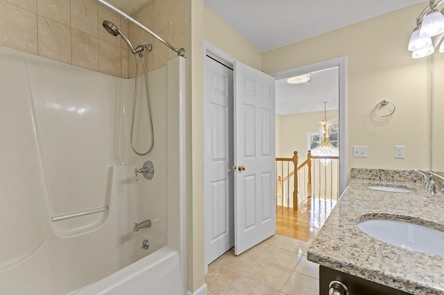 bathroom with double vanity, shower / tub combination, a sink, and tile patterned flooring