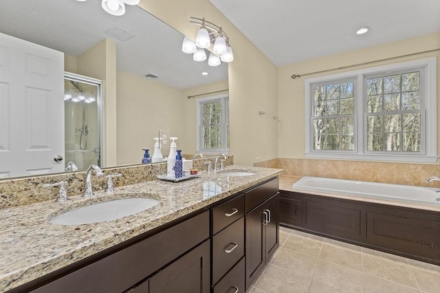 full bath with tile patterned flooring, a sink, and a healthy amount of sunlight