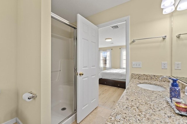 ensuite bathroom with vanity, ensuite bath, tile patterned floors, visible vents, and a stall shower