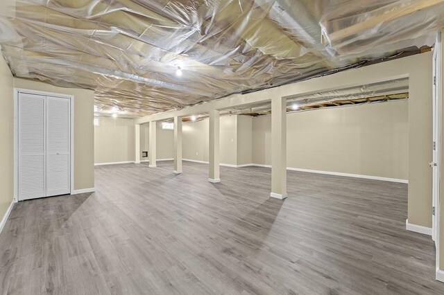 finished basement with baseboards and wood finished floors