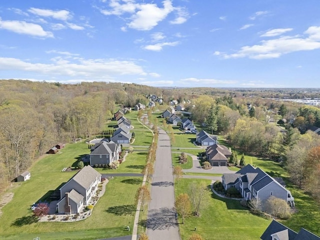 bird's eye view with a wooded view and a residential view