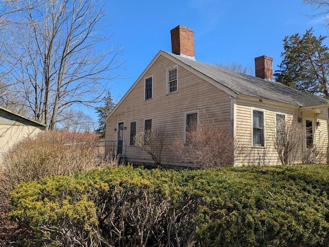 view of property exterior with a chimney