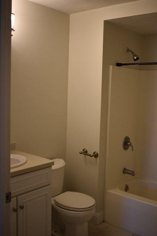 bathroom featuring toilet, tile patterned flooring, shower / tub combination, and vanity