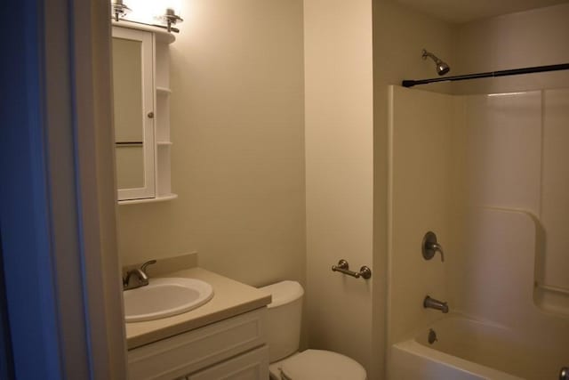 bathroom featuring toilet, washtub / shower combination, and vanity