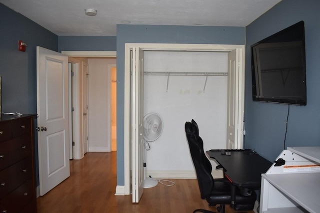 office space featuring baseboards and wood finished floors