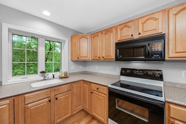 7 Conant Rd Unit 37, Winchester, MA 01890 - kitchen with black microwave, electric stove, a sink, light wood-style floors, and recessed lighting