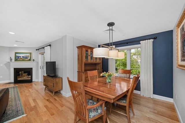 7 Conant Rd Unit 37, Winchester, MA 01890 - dining space with light wood-type flooring, baseboards, a fireplace with flush hearth, and recessed lighting