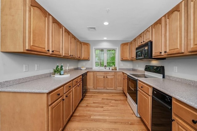 7 Conant Rd Unit 37, Winchester, MA 01890 - kitchen featuring black appliances, light wood-style floors, a sink, light countertops, and recessed lighting