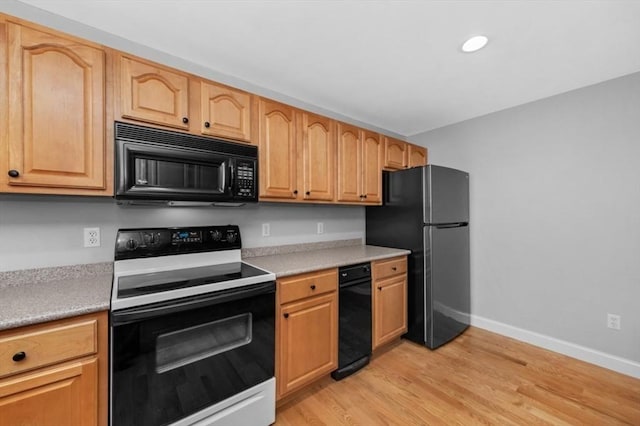 7 Conant Rd Unit 37, Winchester, MA 01890 - kitchen featuring black appliances, baseboards, light countertops, light wood-style floors, and recessed lighting