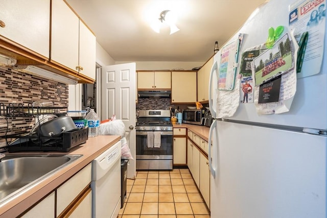27 Harrison St Unit C, Boston, MA 02131 - kitchen featuring stainless steel appliances, tasteful backsplash, under cabinet range hood, light countertops, and light tile patterned flooring
