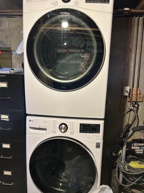 laundry room featuring stacked washer and dryer