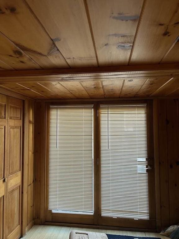 interior space with wood walls and wood ceiling