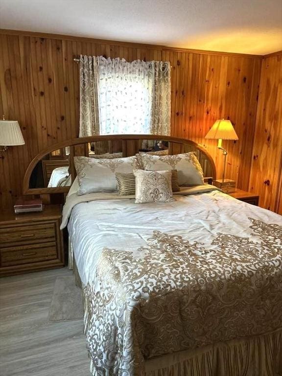 bedroom featuring wooden walls