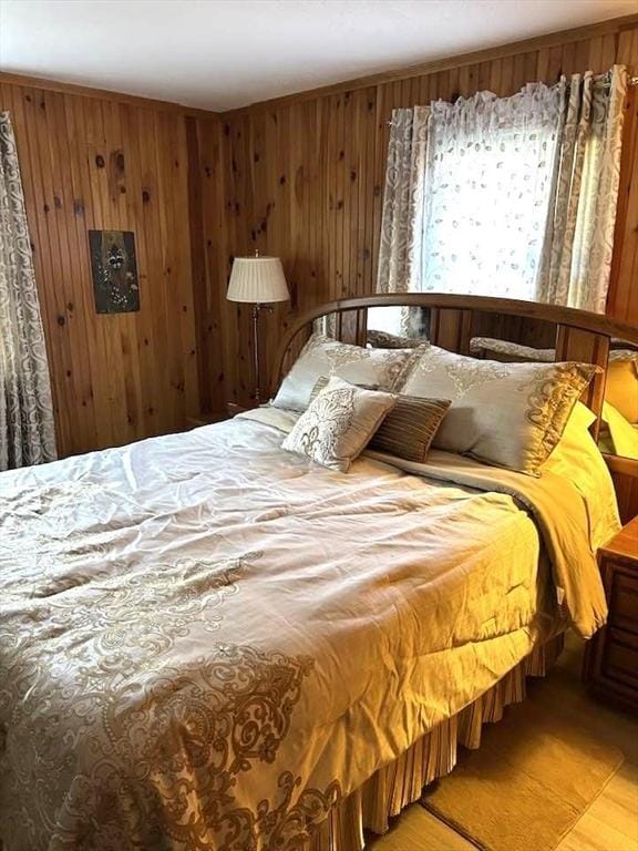 bedroom featuring wood walls