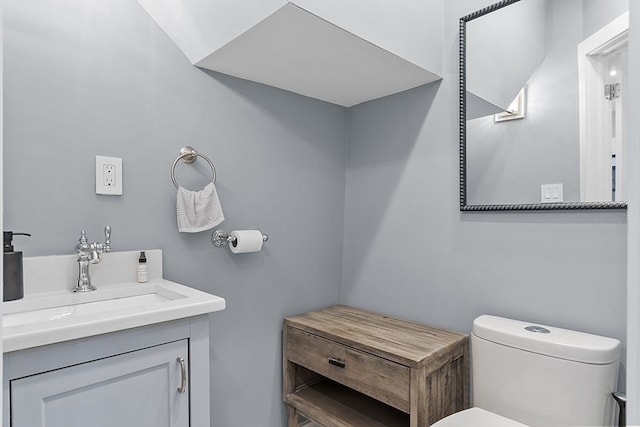 bathroom with toilet and vanity