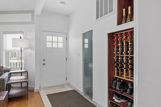 foyer entrance featuring a wealth of natural light and light hardwood / wood-style flooring