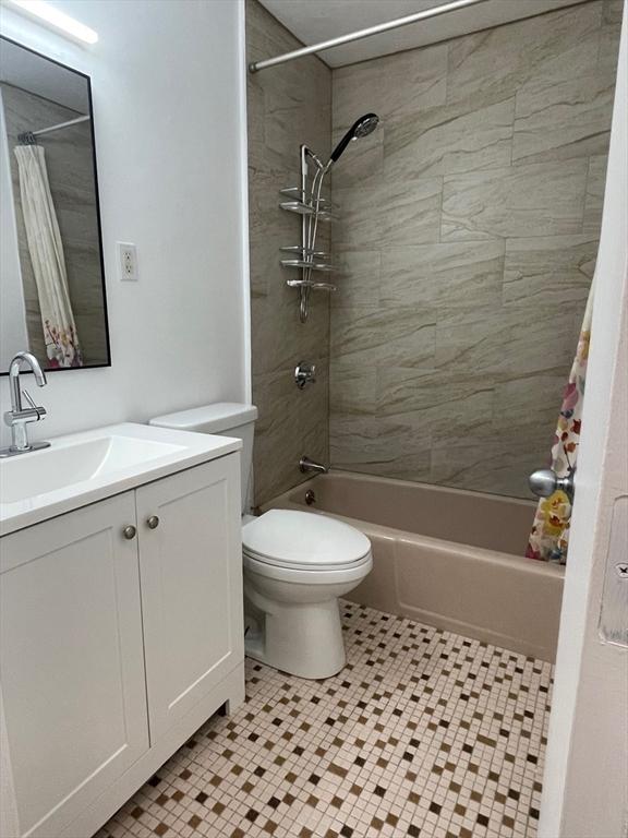 766 Willard St Unit A7, Quincy, MA 02169 - bathroom featuring shower / bathtub combination with curtain, toilet, vanity, and tile patterned floors