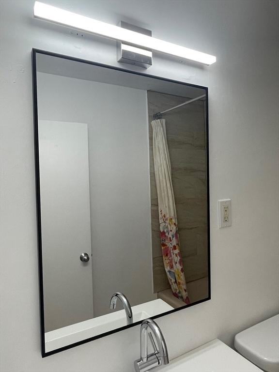 766 Willard St Unit A7, Quincy, MA 02169 - bathroom with toilet, curtained shower, and a sink