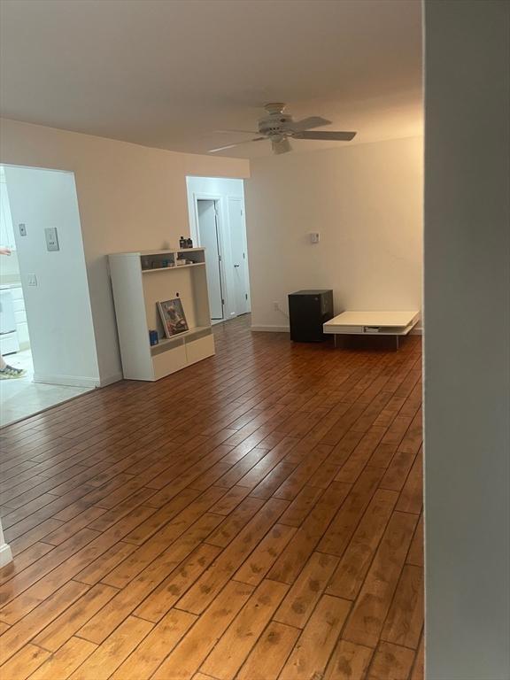 766 Willard St Unit A7, Quincy, MA 02169 - unfurnished living room featuring a ceiling fan, light wood finished floors, and baseboards