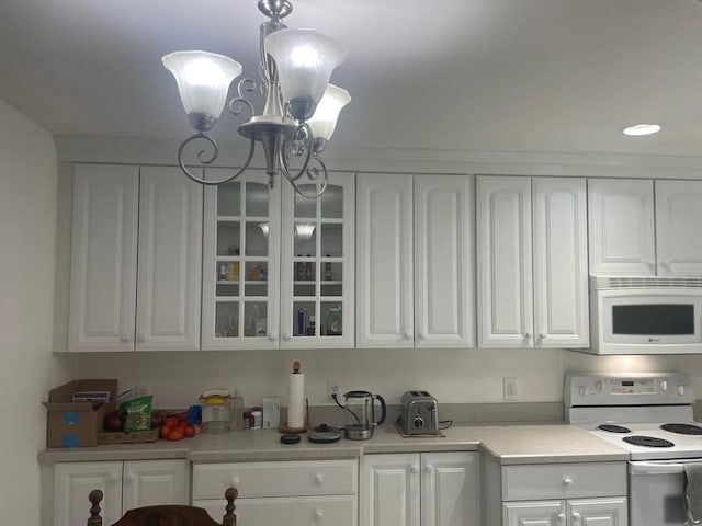 766 Willard St Unit A7, Quincy, MA 02169 - kitchen featuring white appliances, a chandelier, white cabinets, glass insert cabinets, and recessed lighting