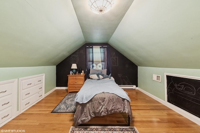 157 Hall St, Mansfield, MA 02048 - bedroom featuring a baseboard heating unit, baseboards, light wood-type flooring, and vaulted ceiling