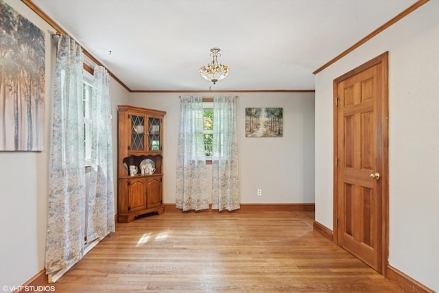 157 Hall St, Mansfield, MA 02048 - unfurnished room with ornamental molding, light wood finished floors, a chandelier, and baseboards