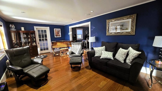 living room with ornamental molding and hardwood / wood-style floors